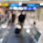 Traveller on moving walkway in airport